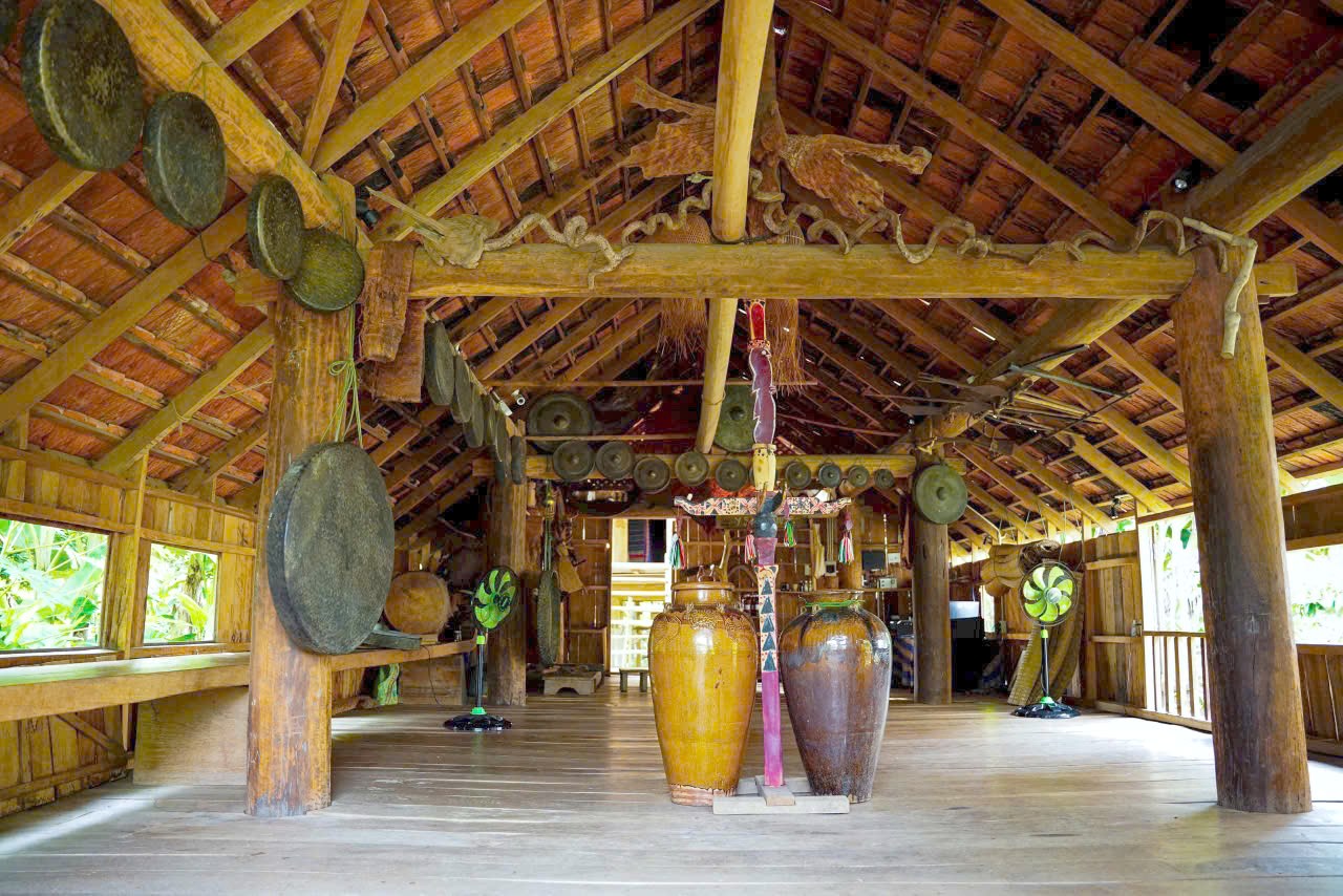 Inside a traditional M'nong house with rice wine jars, Lak Lake