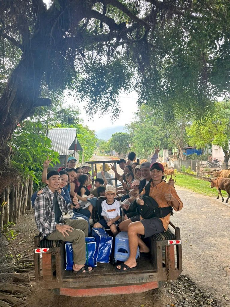 Travelers on a village cart ride near Lak Lake