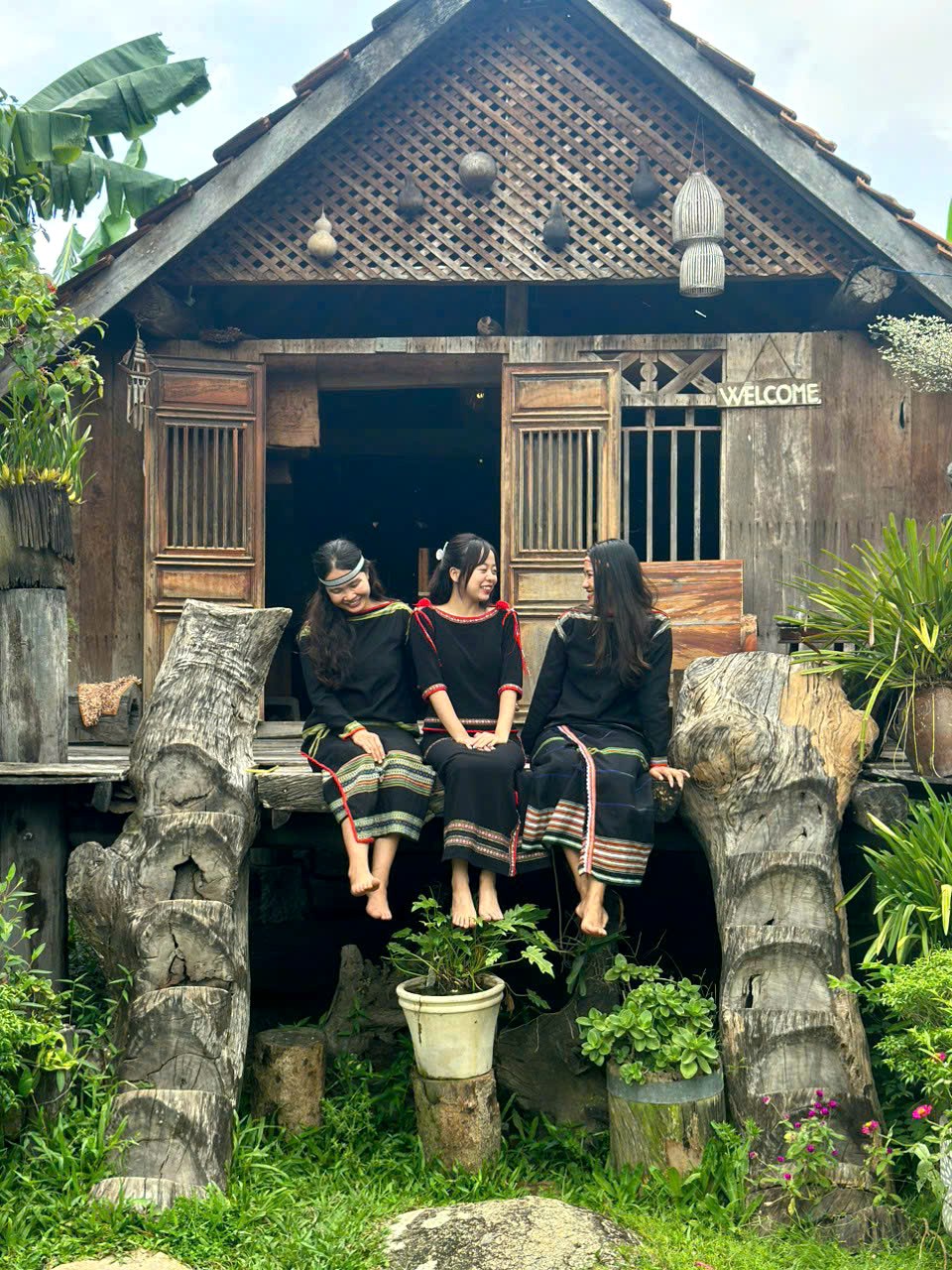 Guests on the porch of a stilt house at Lak Lake