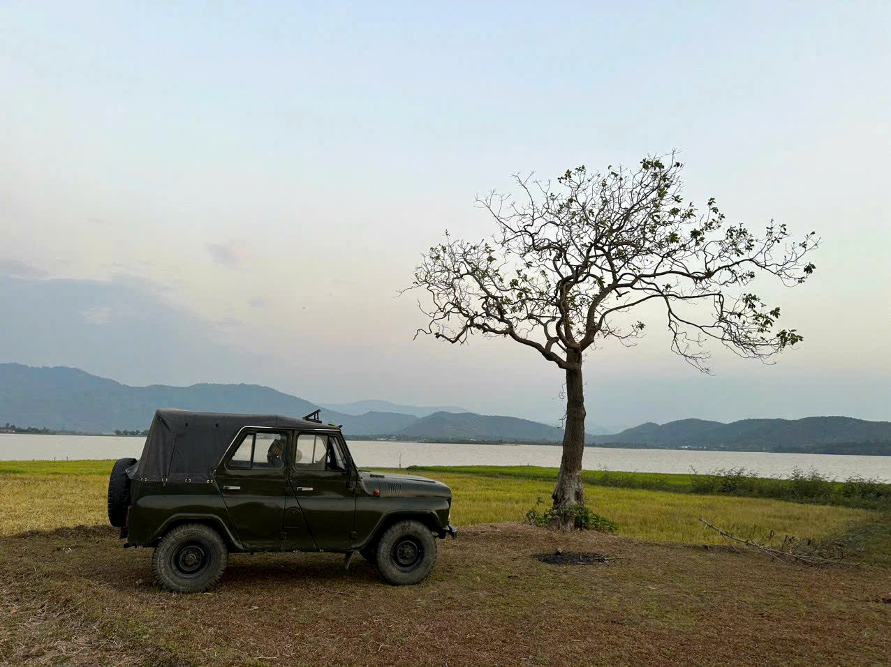 Jeep under a tree by Lak Lake
