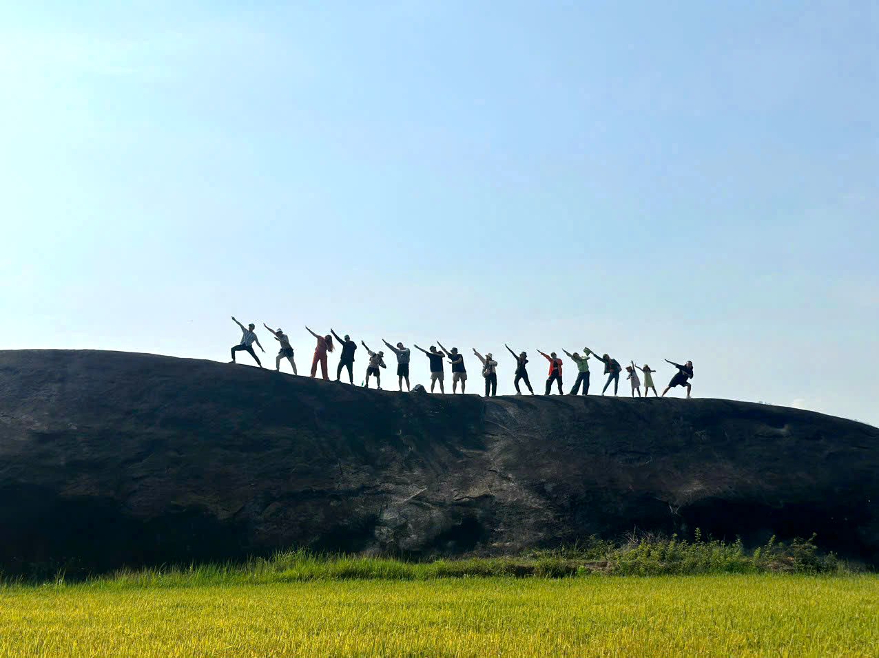 Trekking group celebrating on a rocky ridge of Chu Yang Lak