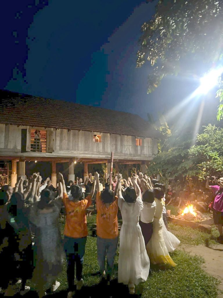 Group dancing around the fire at night